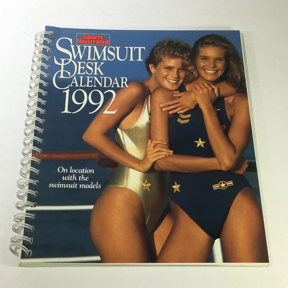 Cover image of the Sports Illustrated 1992 Swimsuit Desk Calendar featuring models Rachel Allison and Elle Macpherson smiling while wearing swimsuits.