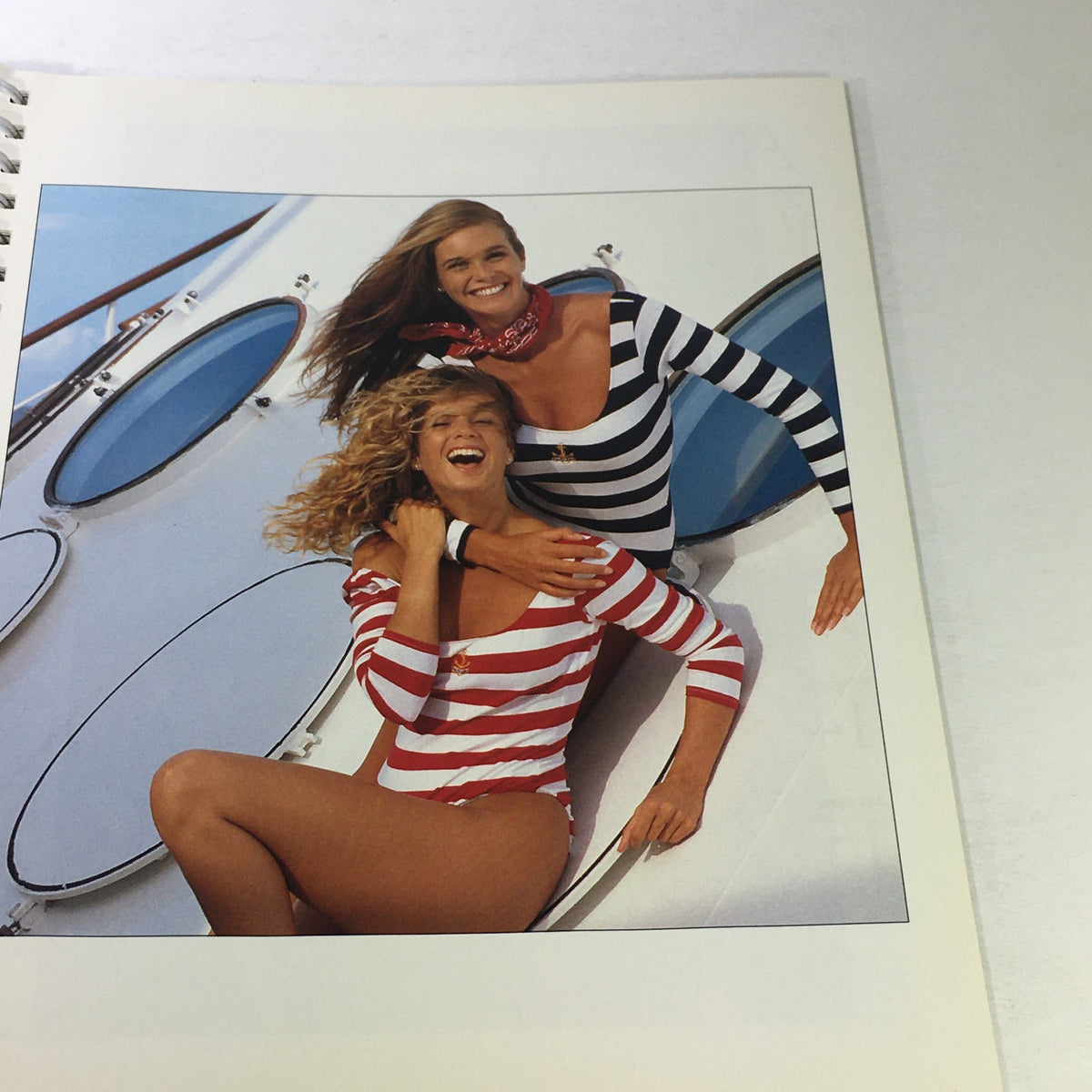 Sports Illustrated 1992 Swimsuit Desk Calendar image of two models playfully posing in striped swimwear, celebrating the fun spirit of early '90s swim styles.