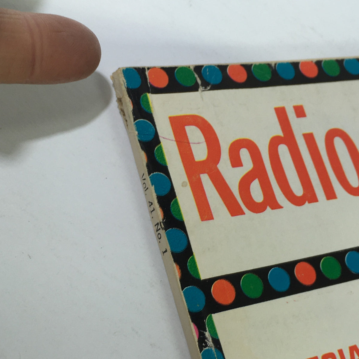 Close-up of the corner of VTG Radio-Electronics Magazine January 1970, featuring colorful polka dot design and title 'Radio' with visible wear on edges.