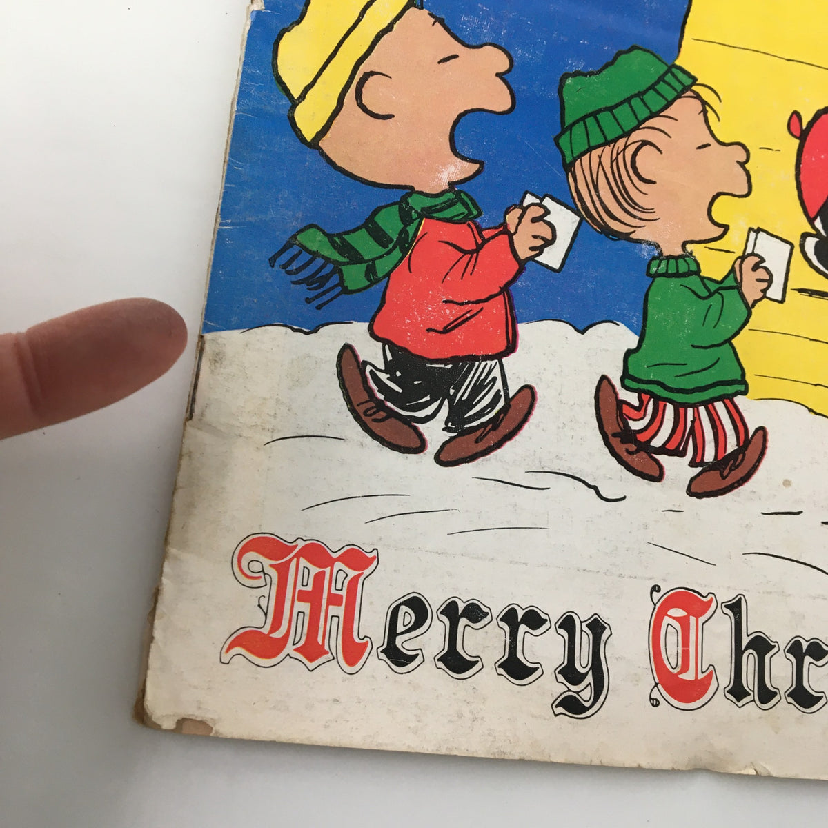 Close-up of the vintage Newsweek magazine cover from December 27, 1971, featuring a colorful illustration of children in winter attire carrying papers, with the text 'Merry Christmas from Snoopy and Friends' prominently displayed. Perfect for collectors and Peanuts fans.
