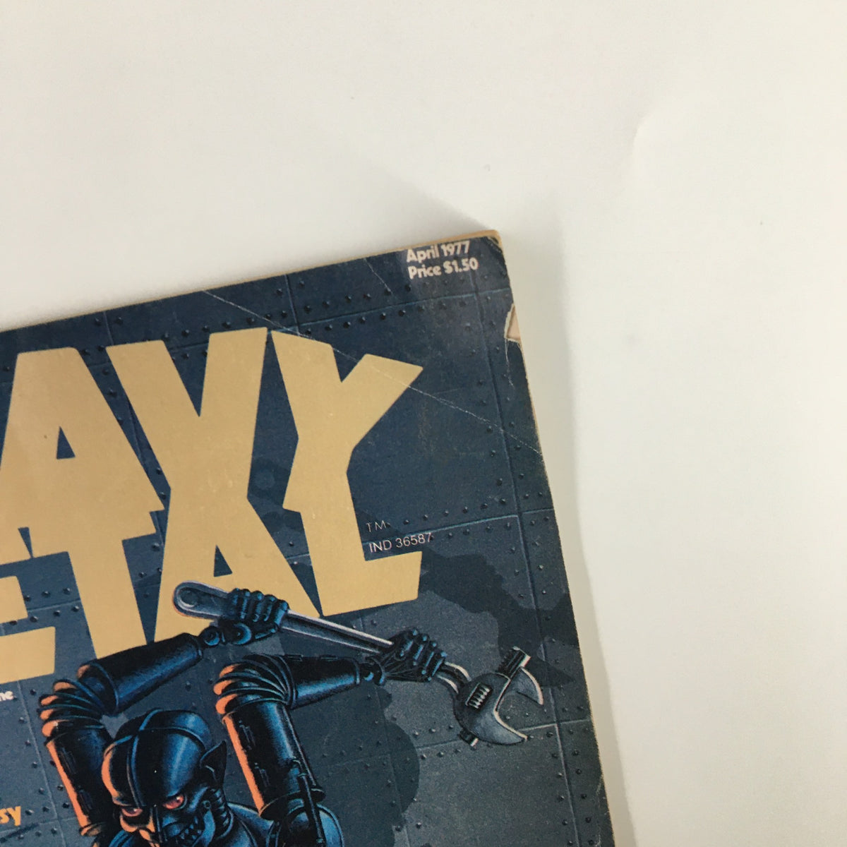 Cover of VTG Heavy Metal Magazine April 1977 featuring The Sword of Shannara. The magazine displays bold gold lettering with an illustration of a robotic character wielding a wrench, set against a dark blue background.