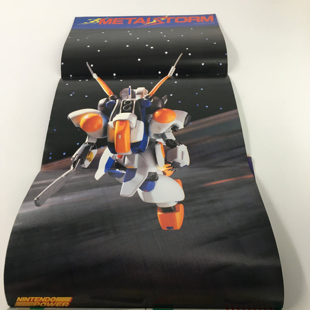 Original Nintendo Power Magazine February 1991 #21 poster featuring a robot from Metal Storm. A collectible piece of retro gaming literature.