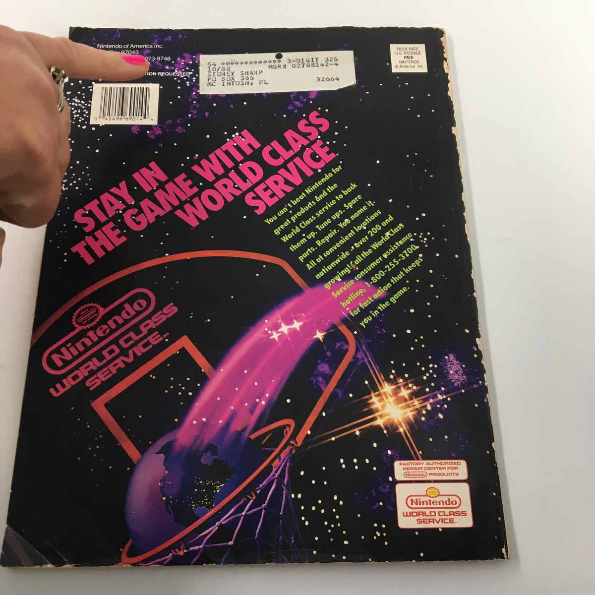 Back cover of Nintendo Power Magazine February 1991 #21 with a promotional design for Nintendo World Class Service, showing address label and wear indicative of its vintage.