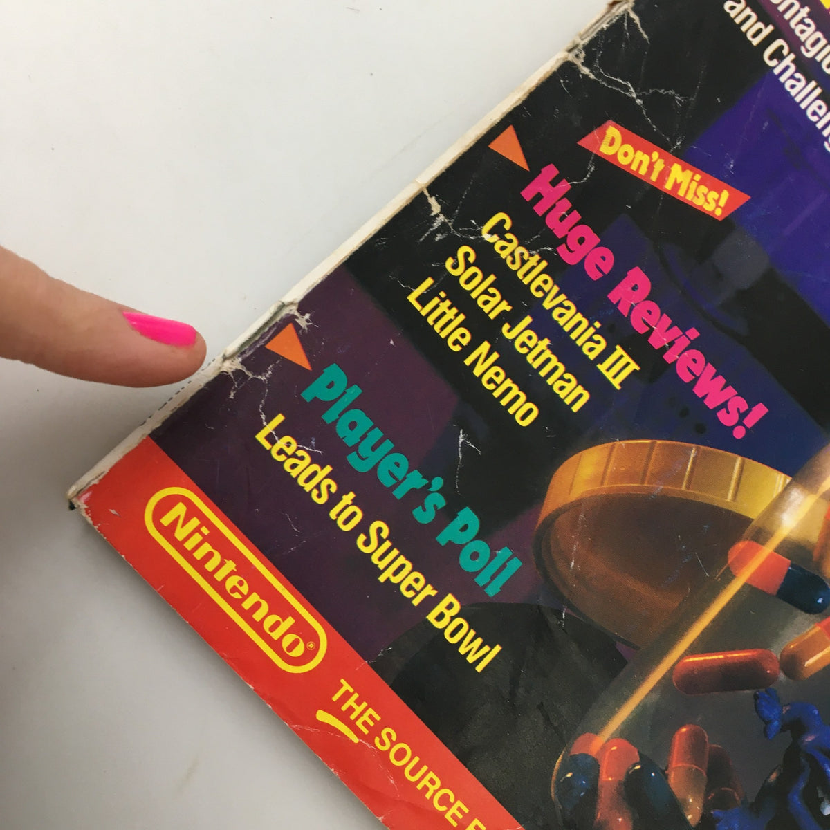 Detail of the lower section on the cover of Nintendo Power Magazine November 1990 #18, discussing huge game reviews and player polls.