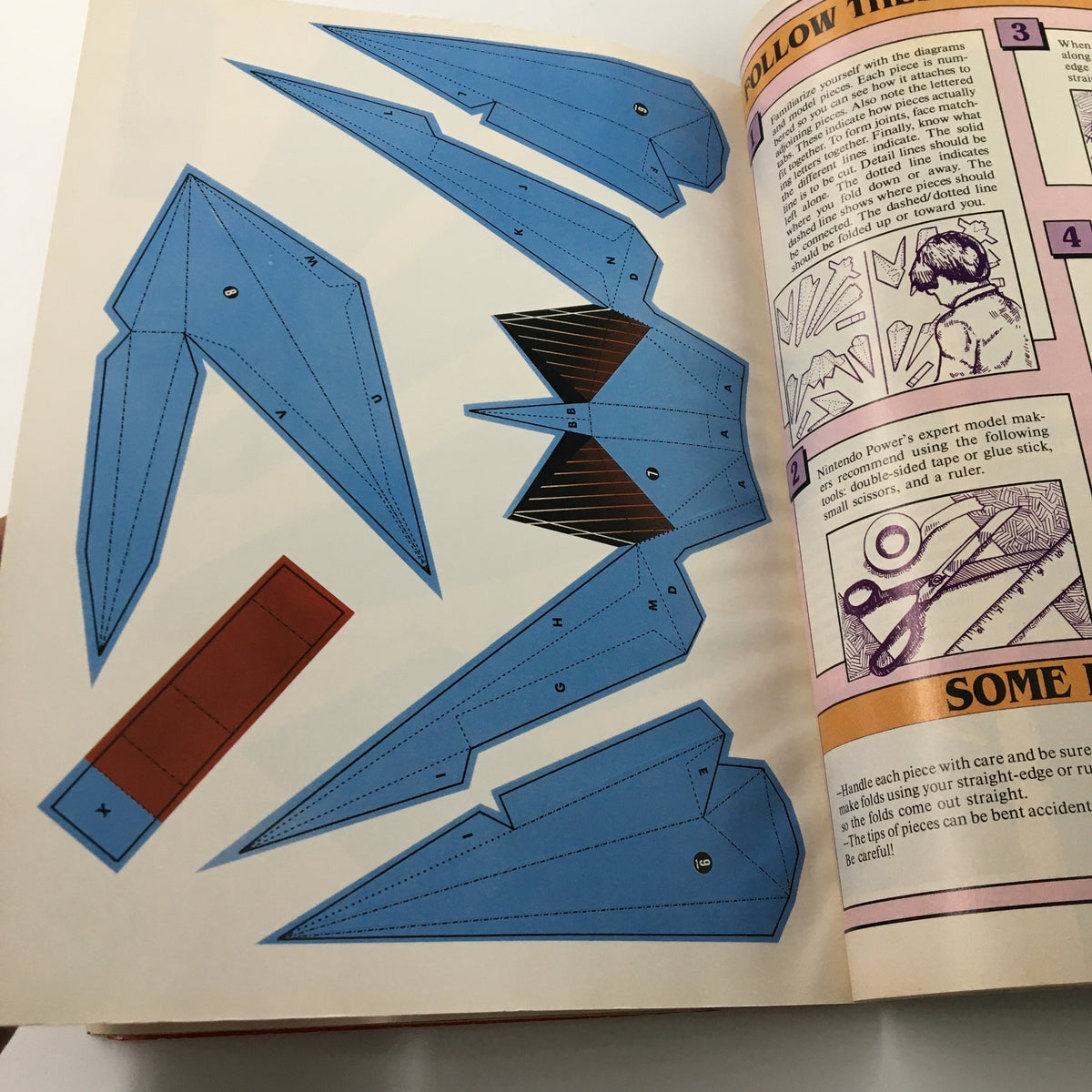 Instruction page from Nintendo Power Magazine January 1993 displaying a model kit assembly guide with blue paper pieces.