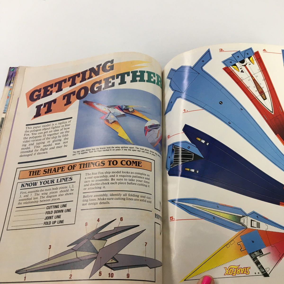 Guide page from Nintendo Power Magazine January 1993 detailing the assembly instructions for a starship model from Star Fox, including visual aids.