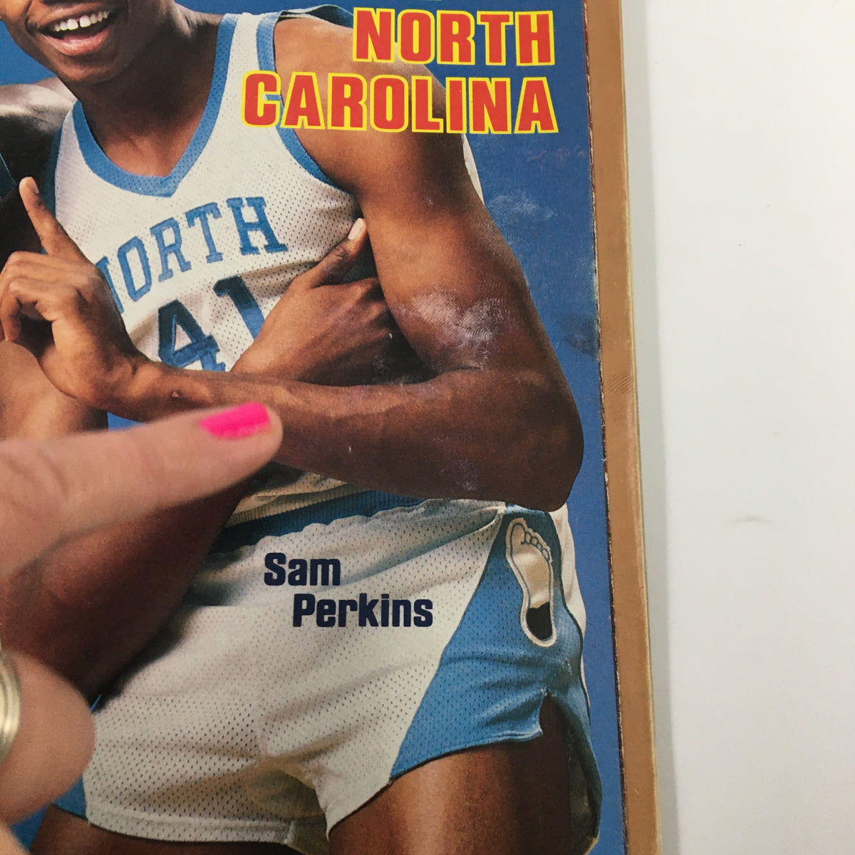 Close-up of Sam Perkins on the cover of VTG Sports Illustrated Magazine from November 28, 1983, highlighting his North Carolina jersey and the magazine's vintage appeal.
