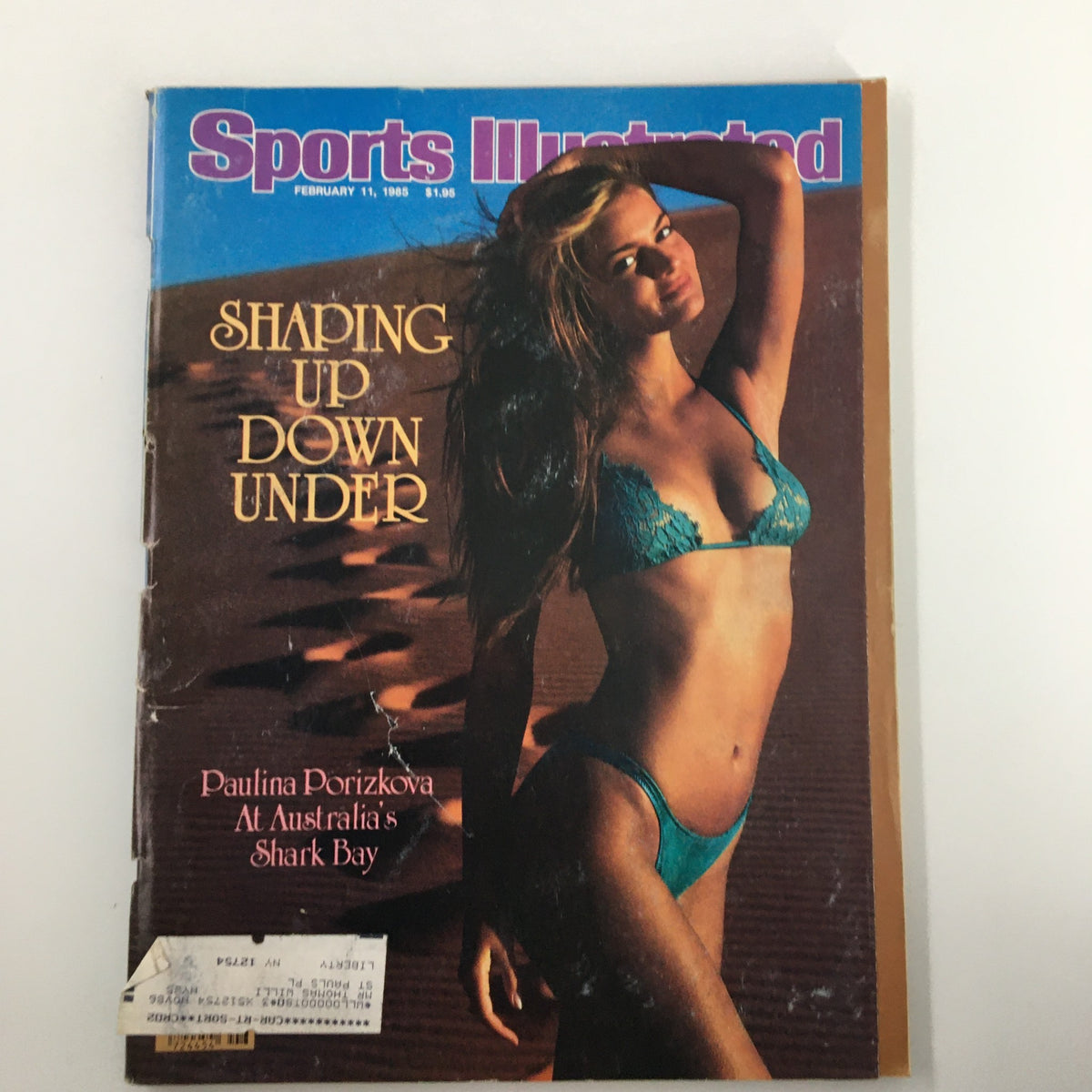 Vintage Sports Illustrated Magazine February 11 1985 cover featuring Paulina Porizkova at Shark Bay in a teal bikini, showcasing mid-1980s fashion.