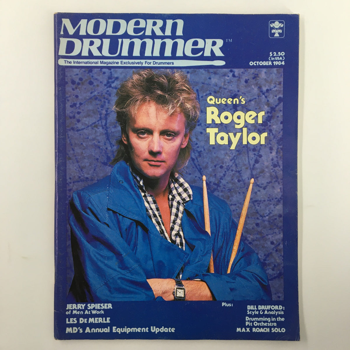 VTG Modern Drummer Magazine October 1984 cover featuring Queen's Roger Taylor, showcasing a photograph of the drummer with drumsticks, highlighting his significance in rock music.