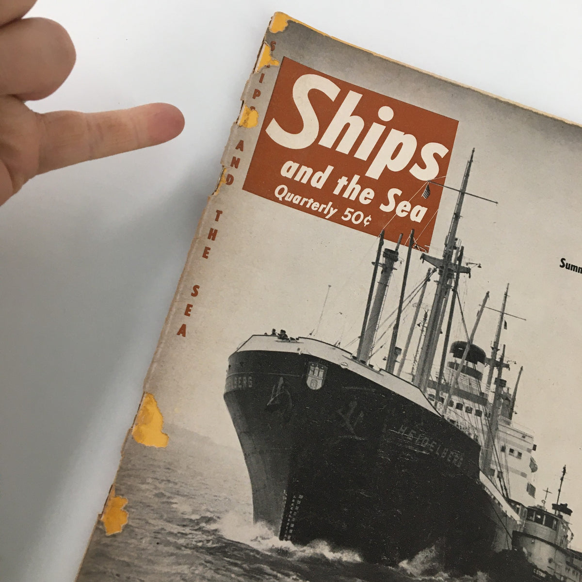 Close-up view of the cover of Ships and the Sea Magazine Summer 1957 with a focus on the ship Heidelberg, highlighting wear typical of a vintage collectible.