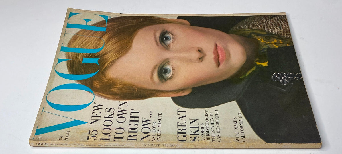 Vogue Magazine August 15, 1967 cover featuring Mia Farrow, showcasing her striking beauty in a matte-black velvet wrap dress photographed by Irving Penn.