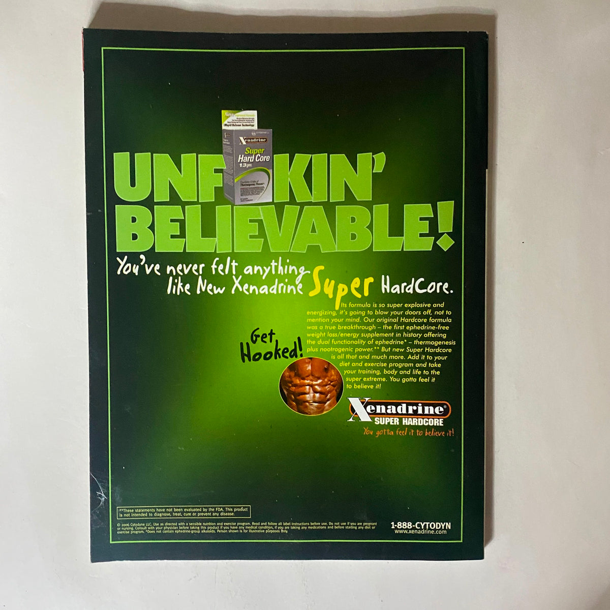 An advertisement for Xenadrine Super Hardcore featuring the slogan 'UNF*CKIN' BELIEVABLE!' This eye-catching design promotes fitness supplements, aligning with the themes of the Fitness RX Magazine November 2006 issue on boosting testosterone and GH naturally.