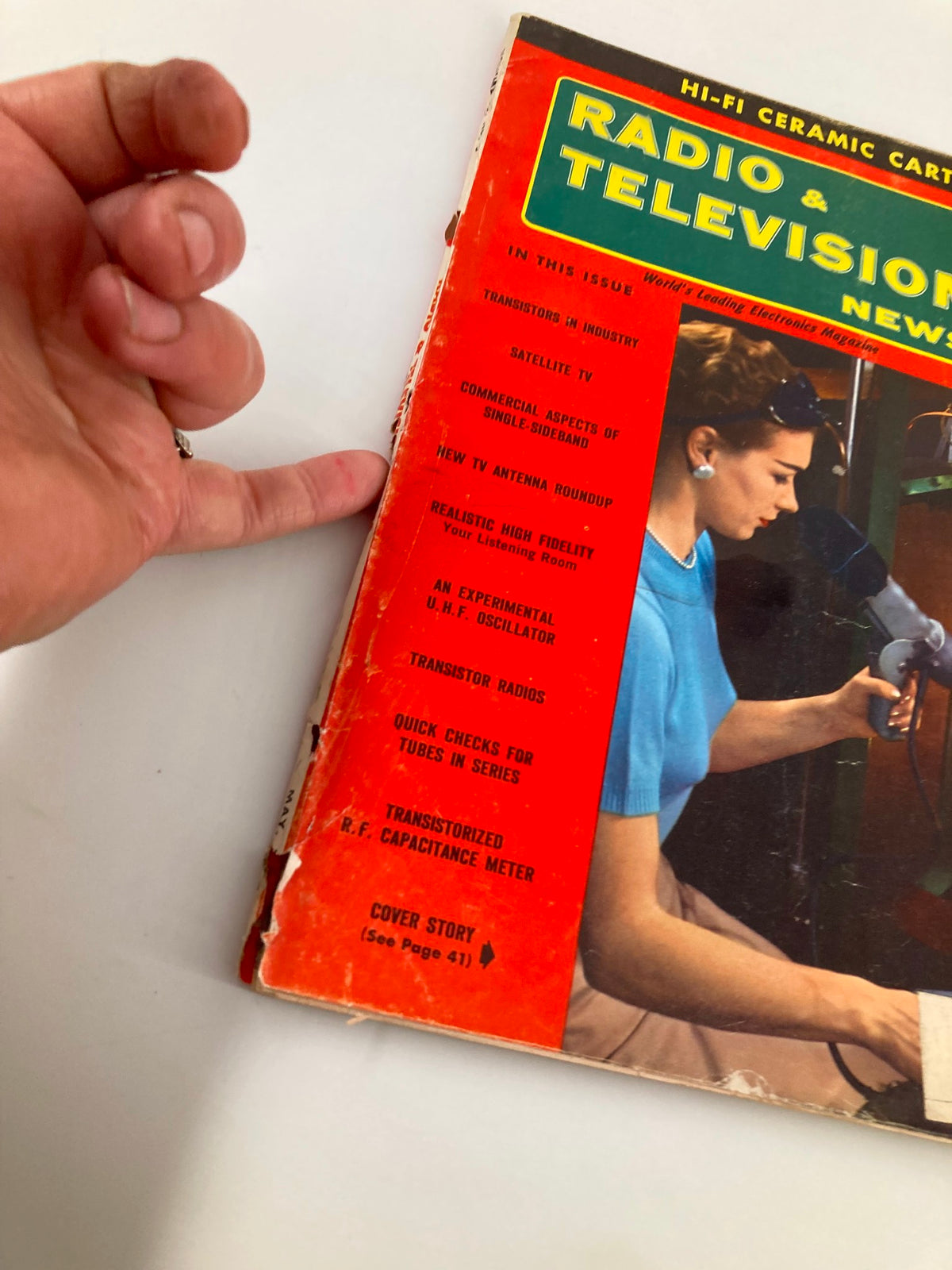 Close-up of the VTG Radio & Television News Magazine May 1956 cover showing detailed sections including features on TV antenna roundups and high fidelity listening rooms.