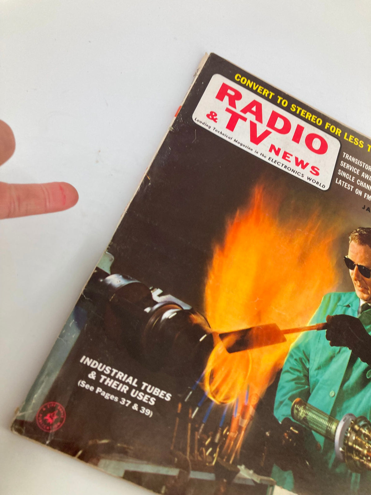Cover of VTG Radio & TV News Magazine January 1959 featuring industrial tubes, highlighting their uses with a vivid illustration of fiery metalwork.
