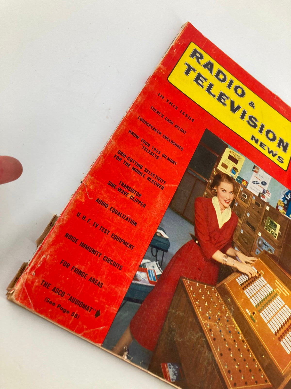 Close-up of the Vintage Radio and Television News May 1953 cover, highlighting articles on audio equalization and featuring a woman in a red dress with a vintage audio device.