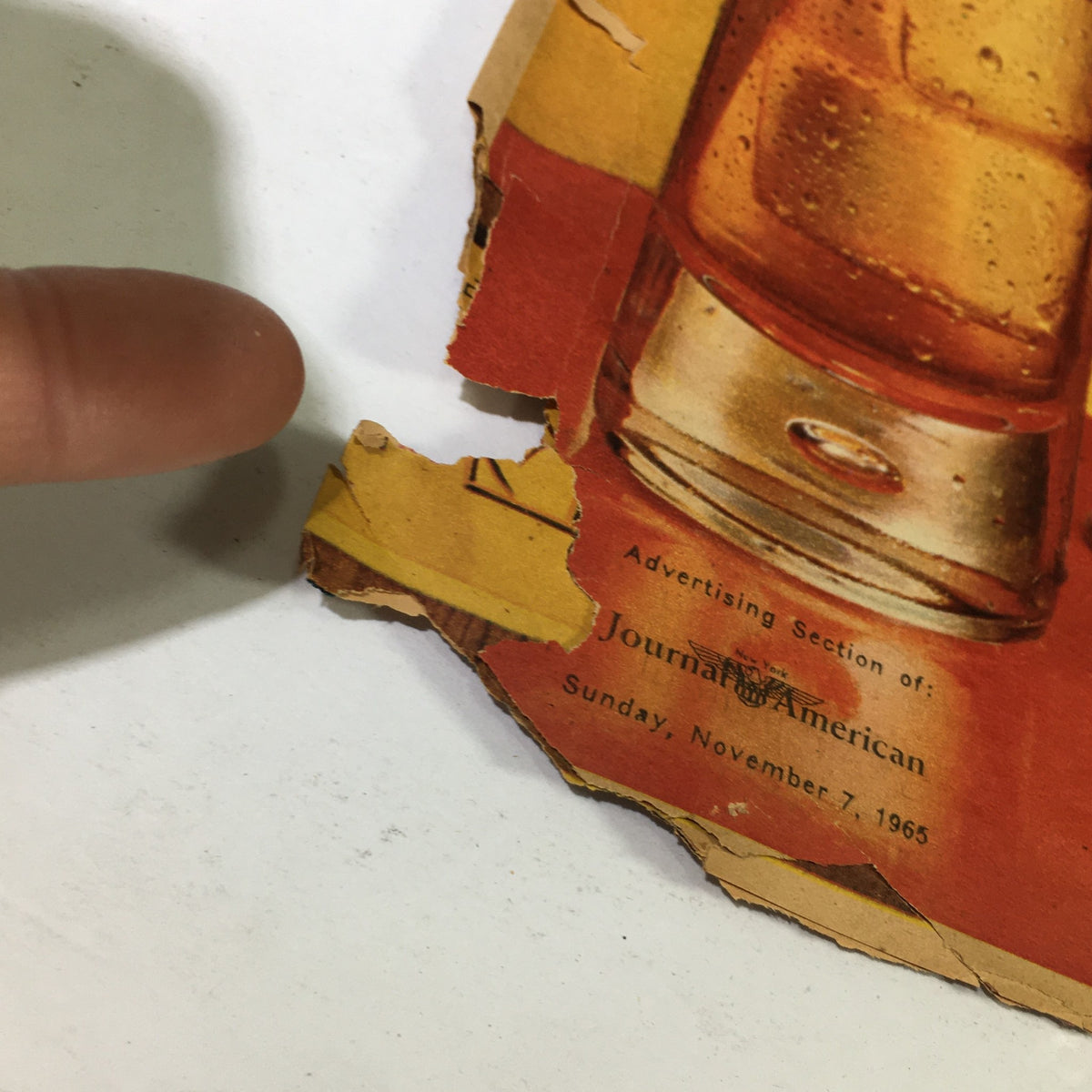 Close-up of the Vintage Journal American magazine showing edges with wear and tear, advertising section noted from November 7, 1965.