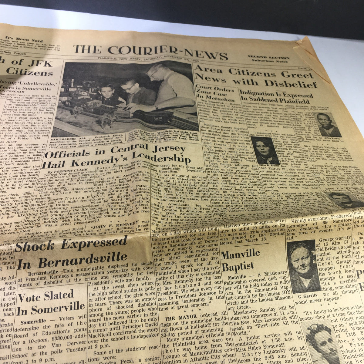 The Courier-News newspaper from November 23, 1963, highlighting officials' reactions to JFK's leadership, with headlines and articles reflecting community sentiments.