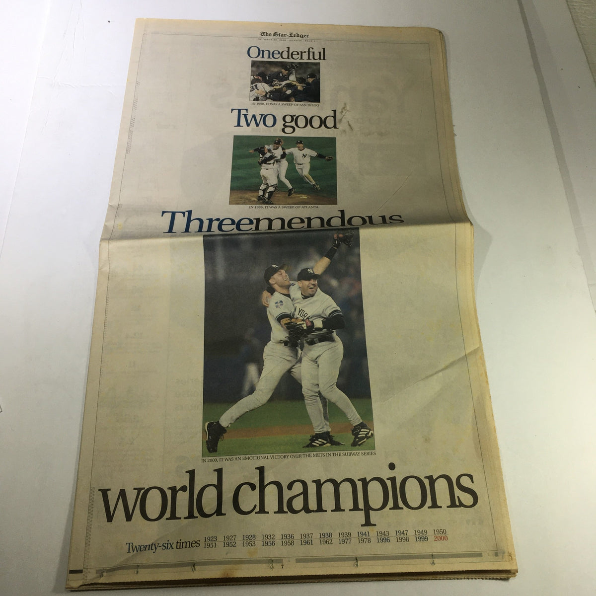 The Star-Ledger Newspaper from October 29, 2000, featuring a headline celebrating the championship victory with the phrase 'world champions' and images of players celebrating. Highlighting sports news related to Mike Piazza and Roger Clemens.