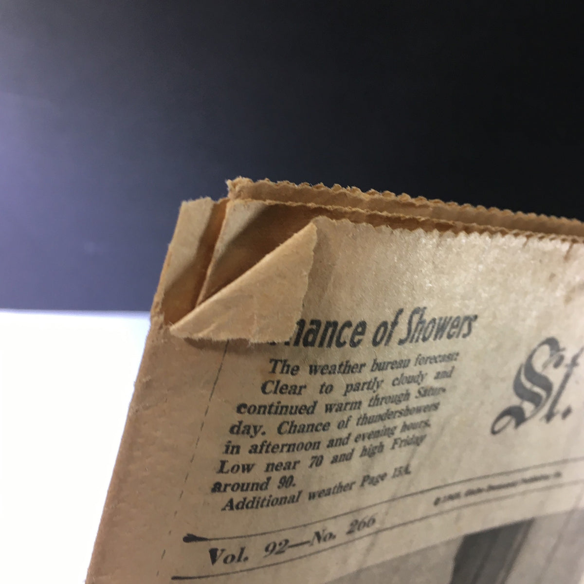 Close-up view of the corner of the VTG St. Louis Globe-Democrat Newspaper from June 7, 1968, highlighting a weather forecast and the vintage paper's aged condition, relevant to the historical context surrounding John and Robert Kennedy.
