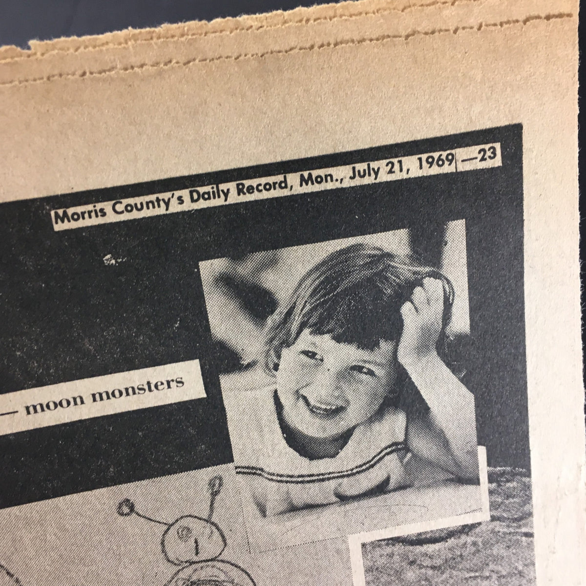 Vintage Morris County Daily Record July 21, 1969, showing a smiling child with the headline about moon monsters.