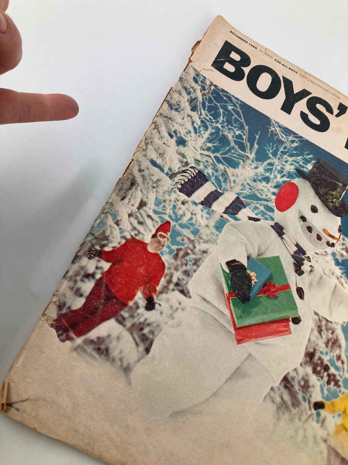 Close-up of Boys' Life Magazine December 1966 cover showing a snowman with gifts and a person in a red coat in the background.
