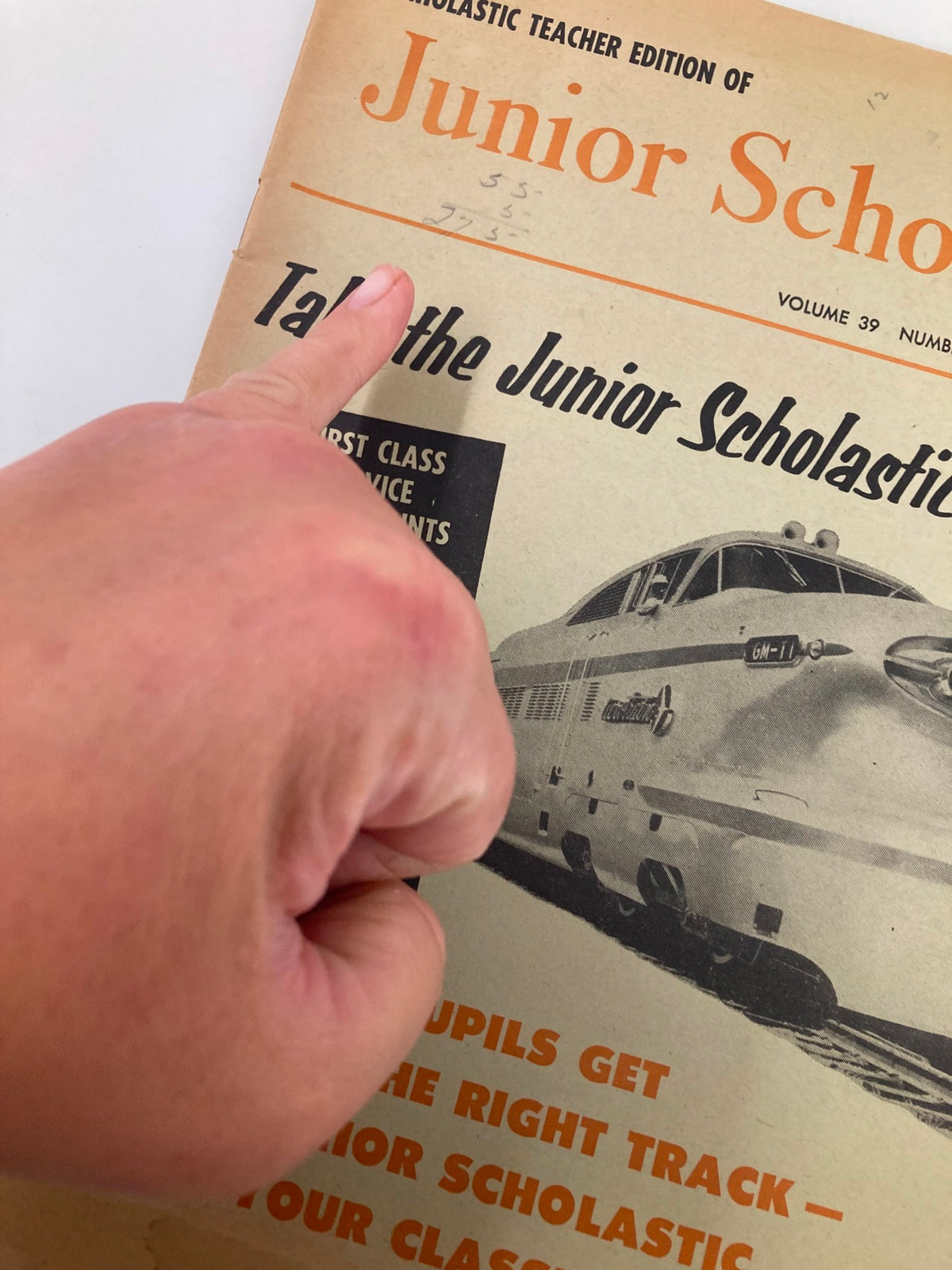Close-up of the cover of VTG Junior Scholastic Magazine September 13 1956, with a hand pointing at the title 'Junior Scholastic' and promotional text highlighting educational features.