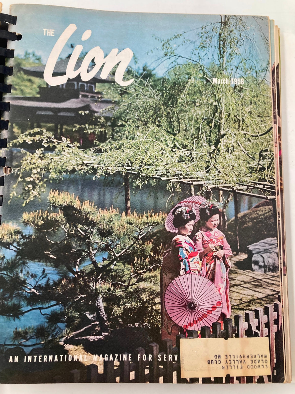 Cover of the March 1958 issue of The Lion Magazine depicting two women in traditional Japanese attire holding umbrellas, set against a serene backdrop, perfect for vintage magazine enthusiasts.