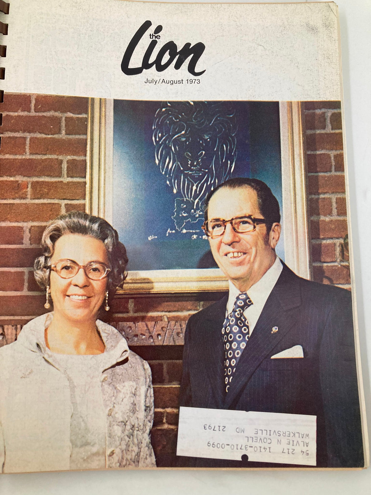 Cover of The Lion Magazine July/August 1973 featuring a portrait of two individuals smiling in a formal setting with a lion artwork in the background.
