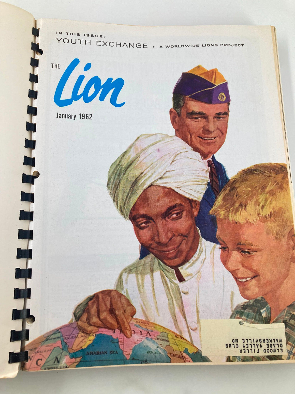 January 1962 cover of The Lion Magazine, featuring a colorful illustration of a boy and a man looking at a globe, emphasizing youth exchange themes.