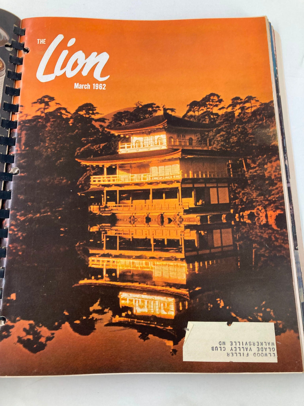March 1962 cover of The Lion Magazine, showcasing a striking image of a pagoda reflected in water, evoking a sense of tranquility and adventure.