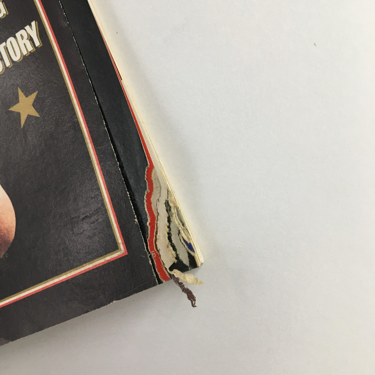 Close-up view of the damaged edge of the Newsweek Magazine from November 18, 1996, showcasing wear and tear, emphasizing its historical significance.
