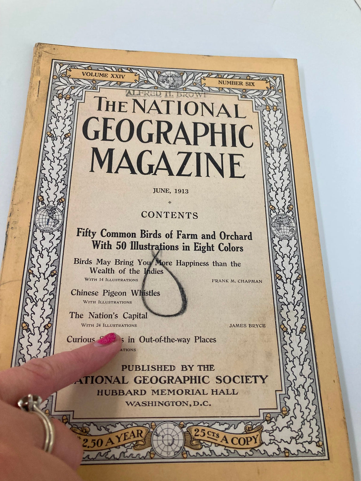 Close-up view of the cover of the June 1913 National Geographic Magazine, showcasing the title along with the contents that include articles on birds, Chinese Pigeon Whistles, and other intriguing topics.