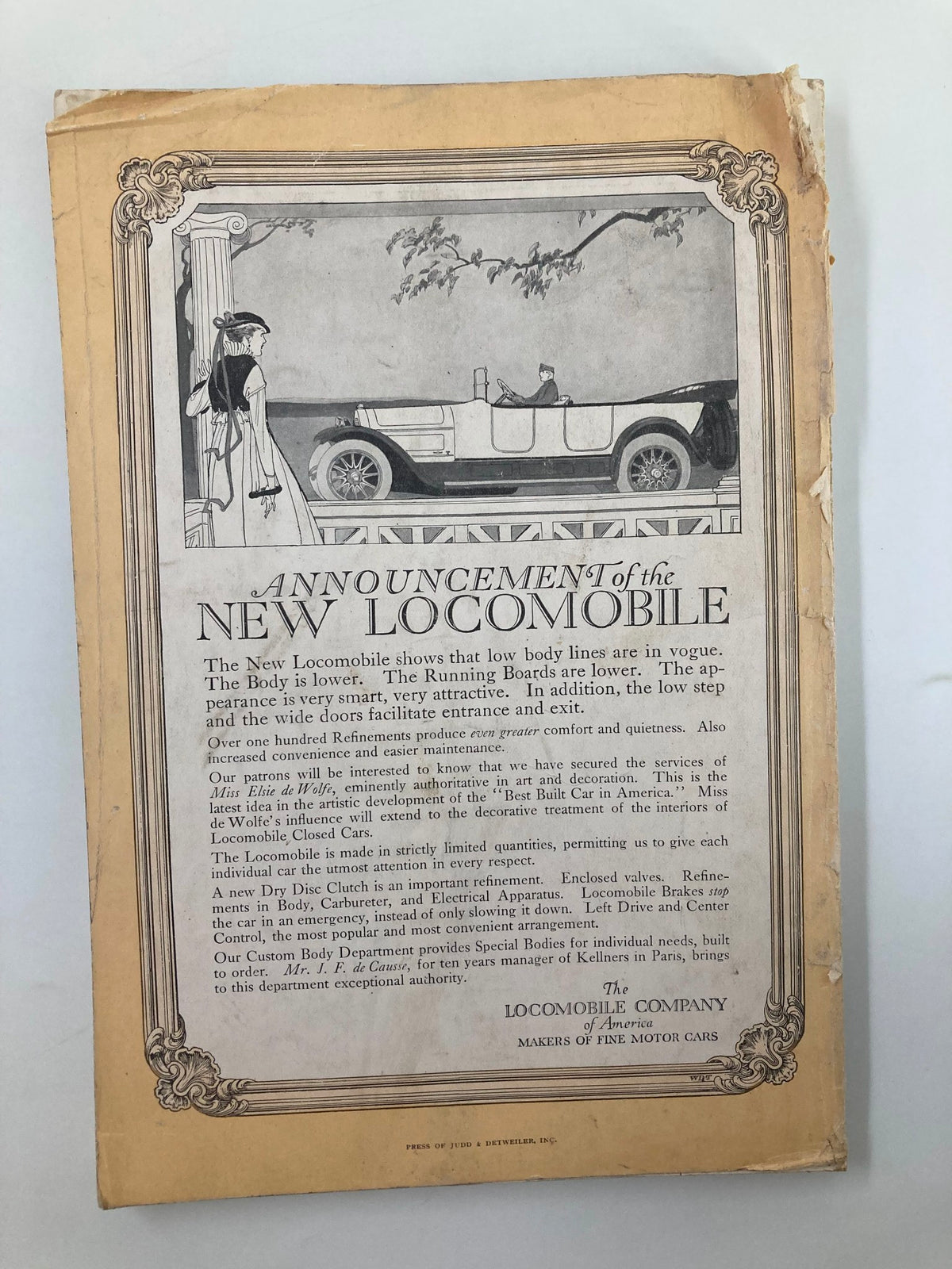 Announcement page for the New Locomobile in the April 1915 issue of The National Geographic Magazine, showcasing a vintage automobile and elegant design.