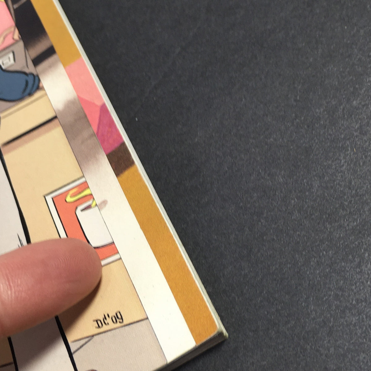 Close-up view of the edge of The New Yorker Magazine from October 12, 2009, showing minor wear and a signature, reflecting its vintage character associated with 'The Food Chain' by Dan Clowes.