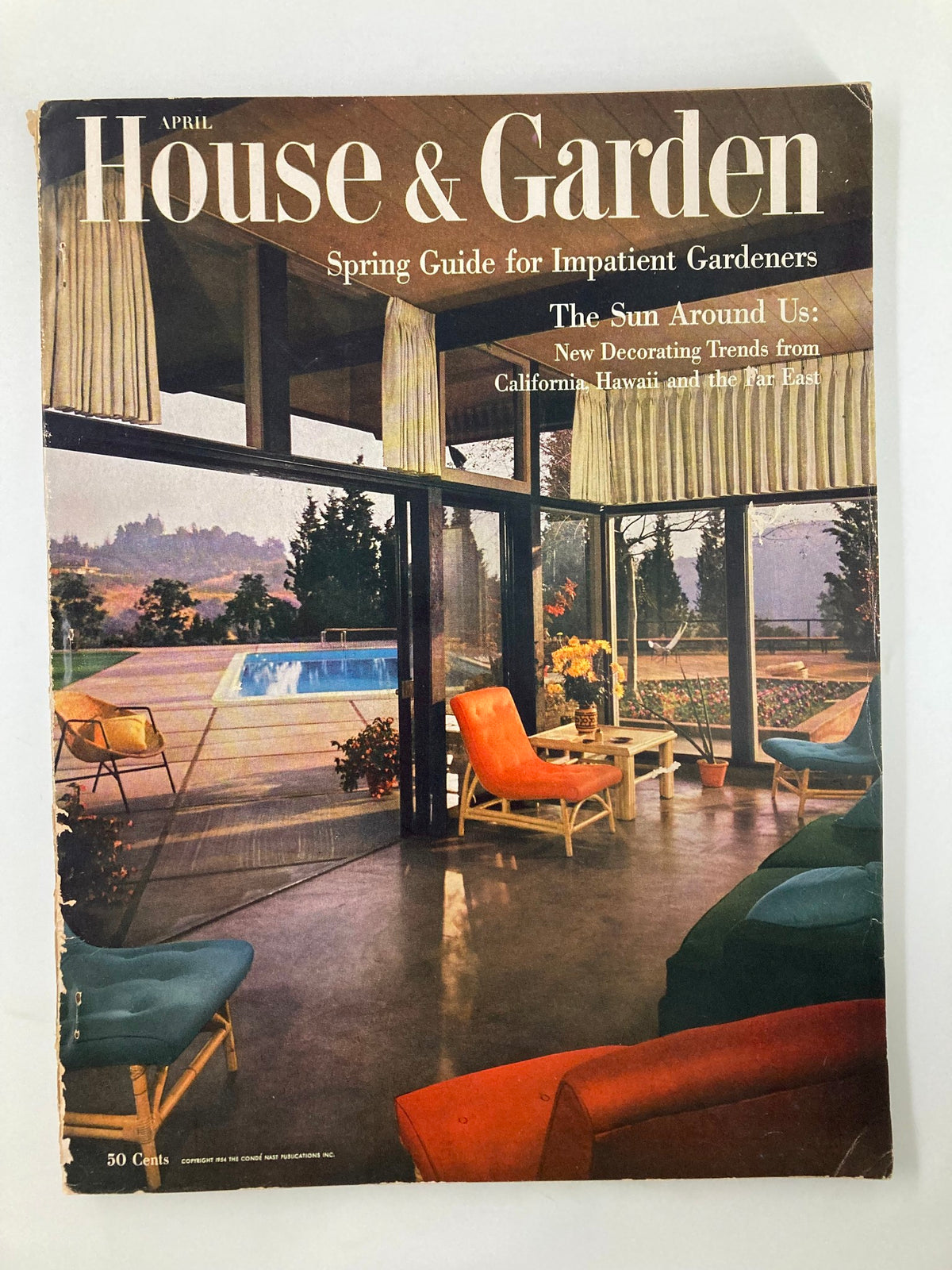 Cover of VTG House & Garden Magazine April 1954 Spring Guide for Impatient Gardeners featuring a stylish living space with colorful chairs, large windows, and a view of a swimming pool.