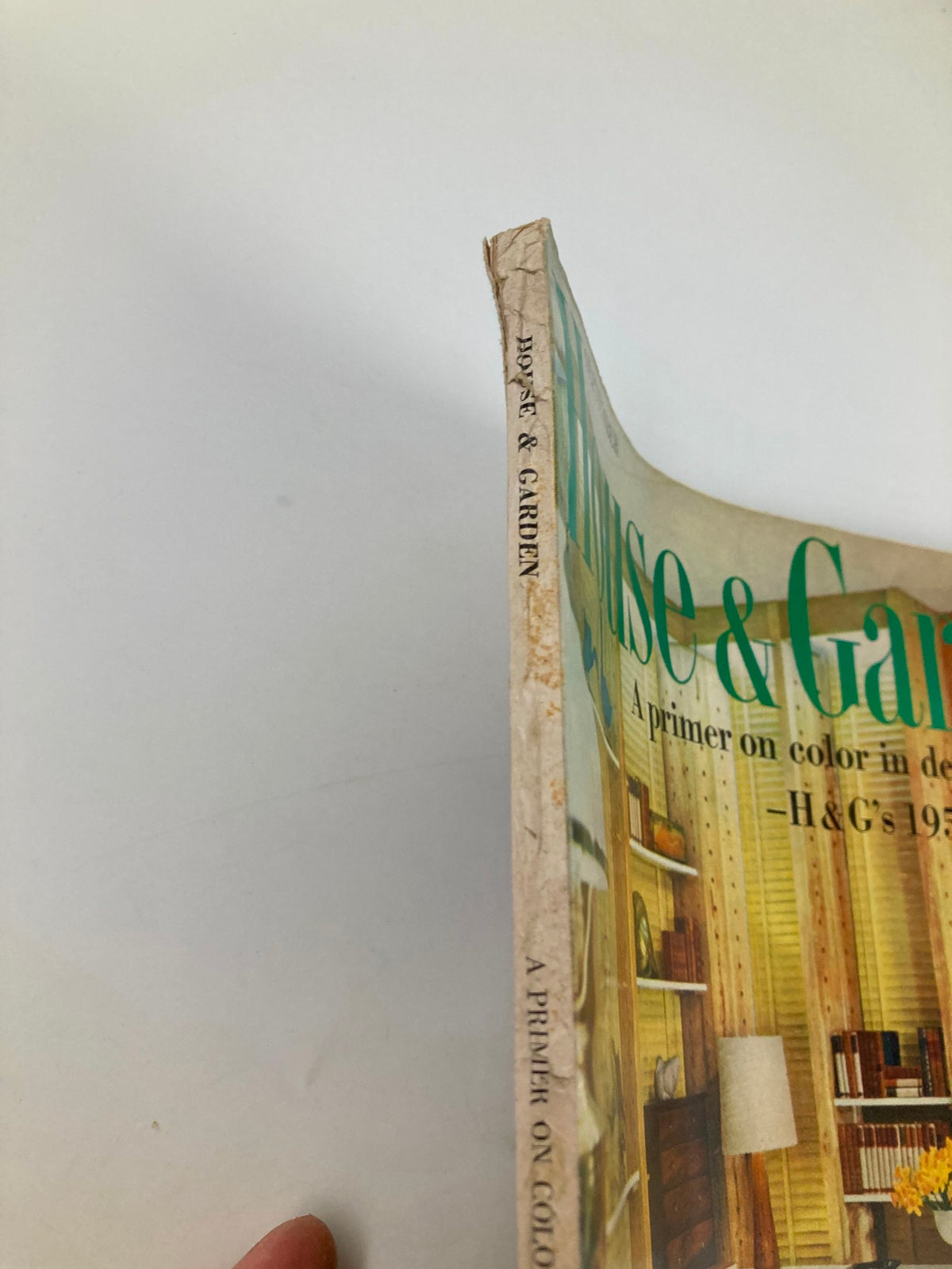 Side view of the VTG House & Garden Magazine from September 1957, titled 'A Primer on Color in Decorating.' The magazine shows minor wear on the spine, indicating its vintage status.