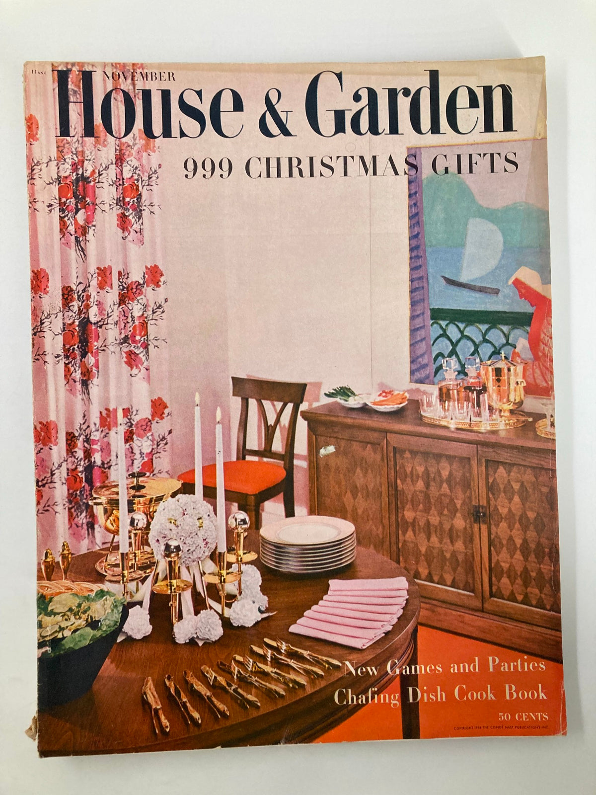 Cover of VTG House & Garden Magazine from November 1954 featuring a festive dining setting with chafing dishes, flowers, and decorative items.