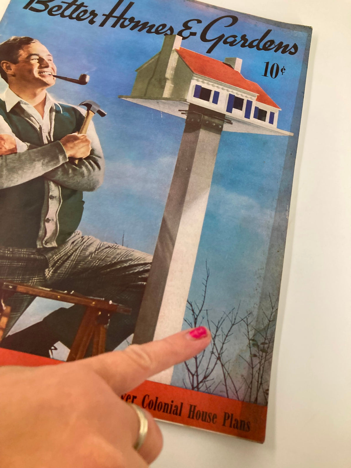 Close-up view of the cover of VTG Better Homes & Gardens Magazine March 1940, depicting a man with a pipe and hammer next to a unique birdhouse, showcasing the title 'Plant-Raising Bugaboos on the Run'.