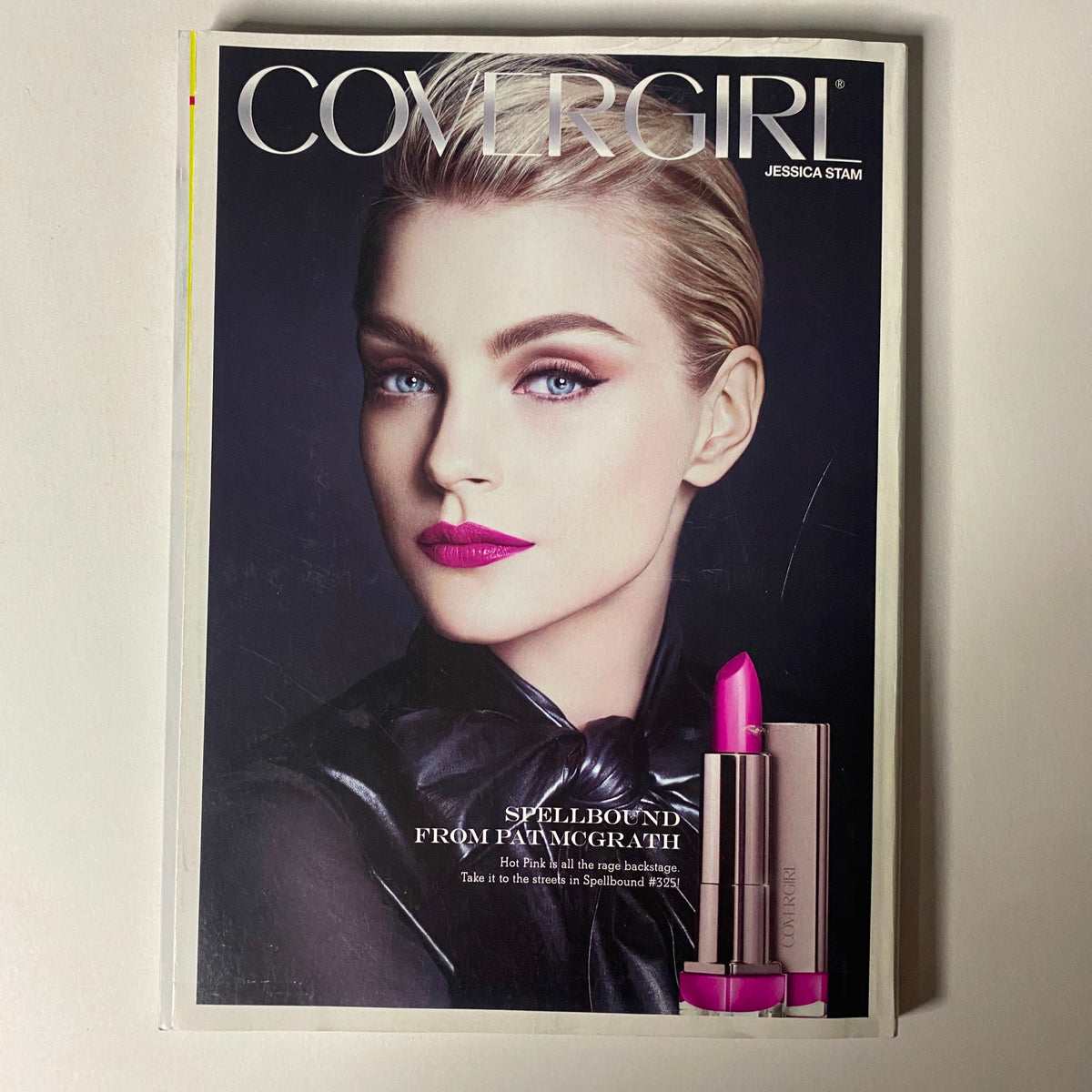 CoverGirl advertisement from Vogue Magazine April 2012 featuring model Jessica Stam with striking makeup and vibrant lip color.