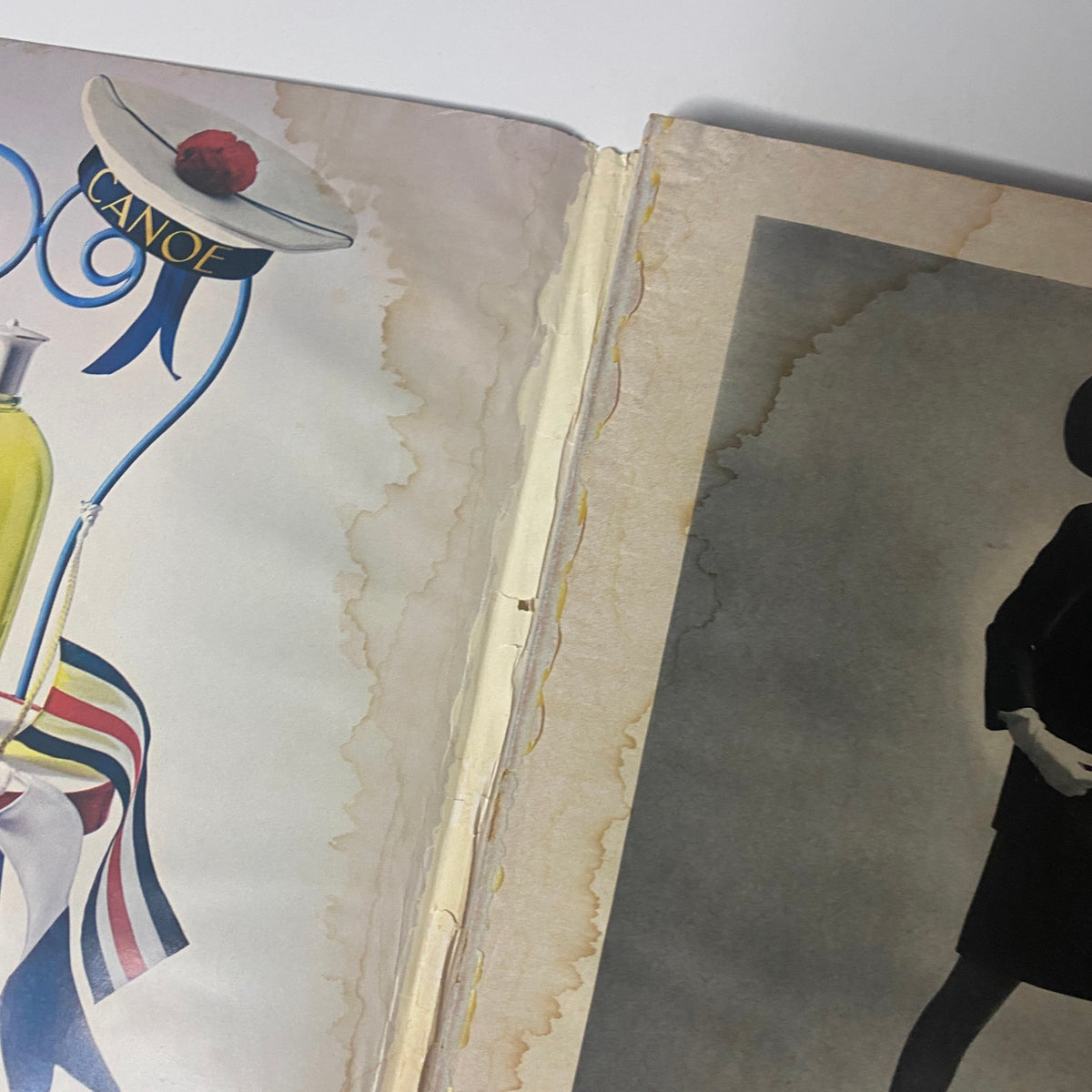 Close-up of a page from Vogue Magazine March 1, 1967, showing an advertisement layout and some damage along the spine, illustrating the vintage appeal of the publication.