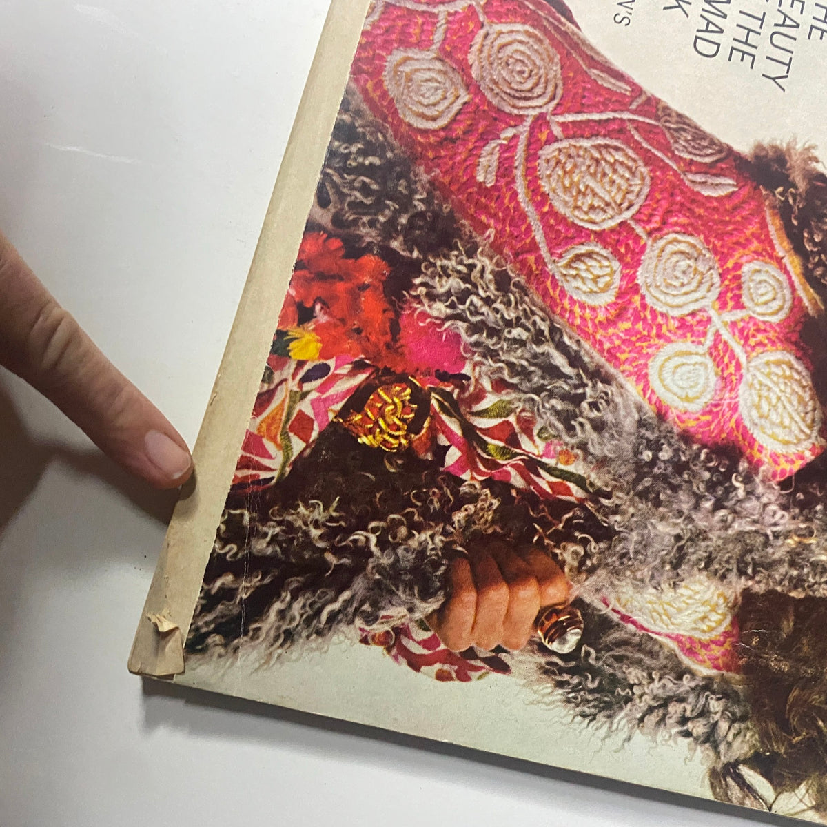 Close-up of the corner of Harper's Bazaar Magazine August 1968 cover by Bill King, showcasing textured fabric and hand detail.