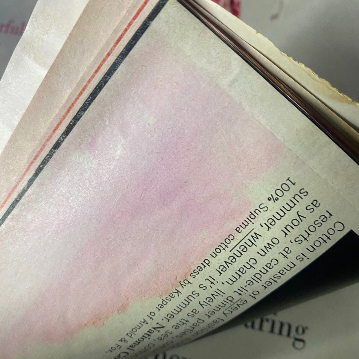 Close-up of a pink-toned page in Harper's Bazaar Magazine December 1960, highlighting luxurious fabric details.