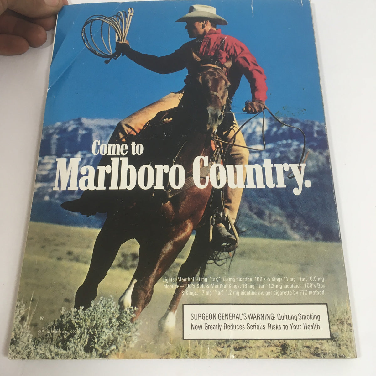 Advertisement from the Official Super Bowl XXV Game Program January 27, 1991, featuring a cowboy promoting Marlboro cigarettes.