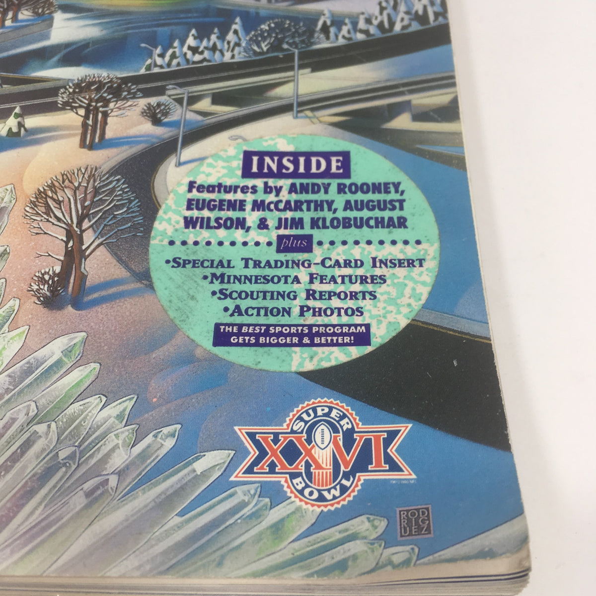 Inside cover of the Super Bowl XXVI Game Program from January 26, 1992, featuring highlights such as contributions from Andy Rooney, Eugene McCarthy, August Wilson, and Jim Klobuchar, alongside special inserts and action photos.