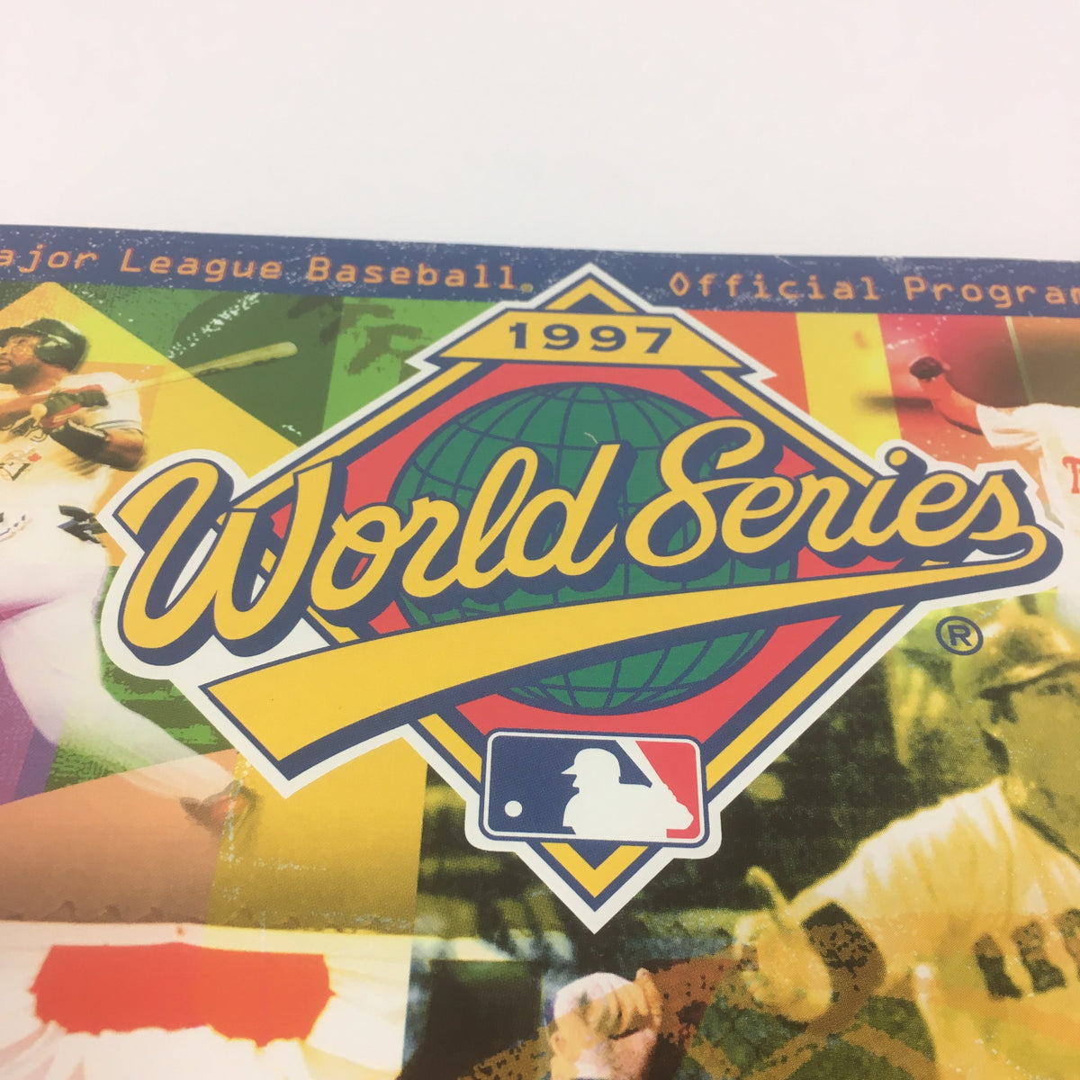 Close-up of the 1997 World Series logo featured on the Major League Baseball Official Program, highlighting its colorful design.