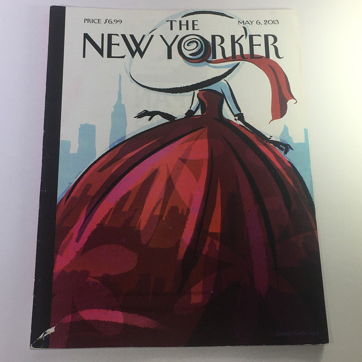 Cover of The New Yorker May 6, 2013 magazine featuring vibrant artwork by Birgit Schössow, showcasing a woman in a striking red dress against a city skyline.