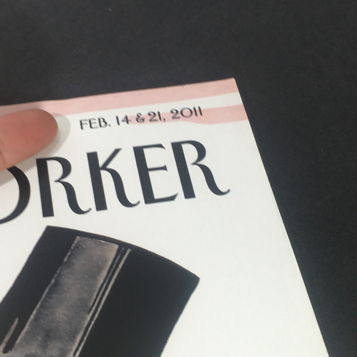 Close-up view of The New Yorker February 14 & 21 2011 magazine cover, highlighting the date and details of the vintage publication.