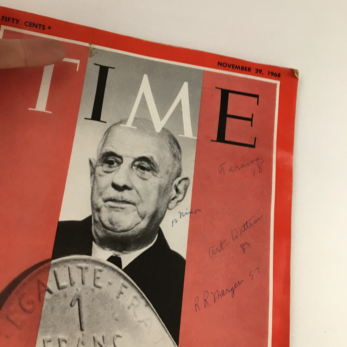 Close-up view of Time Magazine November 29 1968 cover with Charles de Gaulle, showing handwritten notes and the 1 franc coin prominently featured.