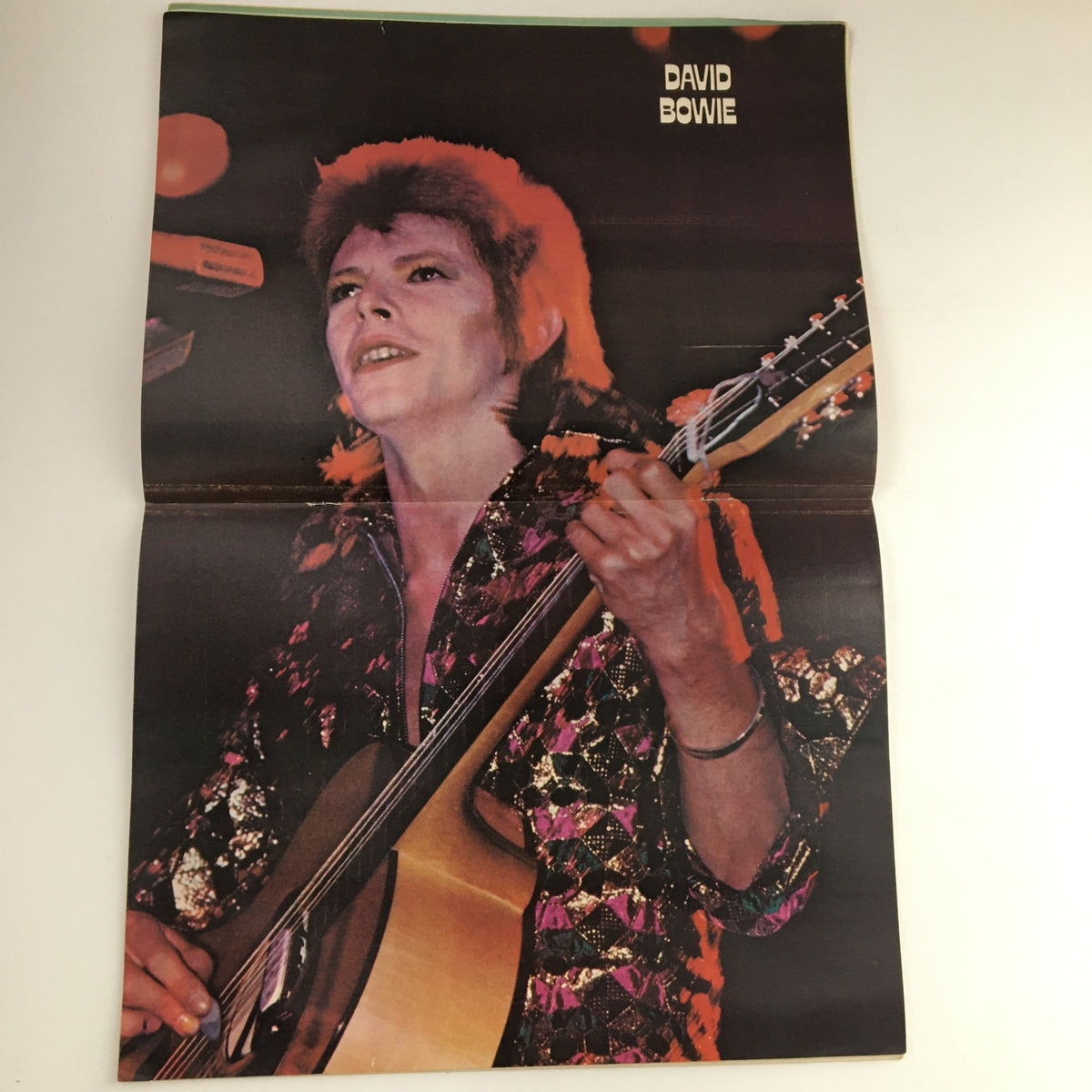Poster of David Bowie included in Hit Parader Magazine April 1973, featuring a vibrant image of the iconic artist performing.