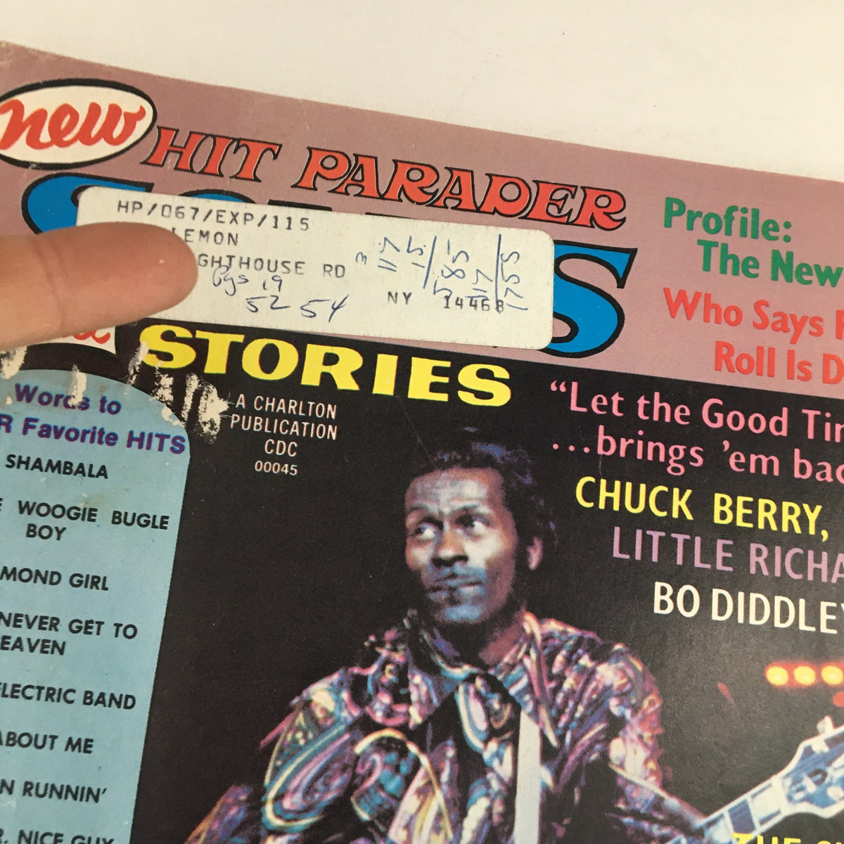 Close-up of the Hit Parader Songs & Stories, October 1973 cover, emphasizing Chuck Berry and the magazine's vintage appeal with details like a handwritten address label and headlines promoting iconic musical figures.